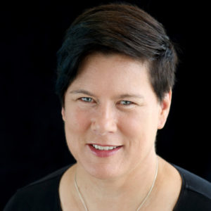 head and shoulders portrait of jean burgess against a black background